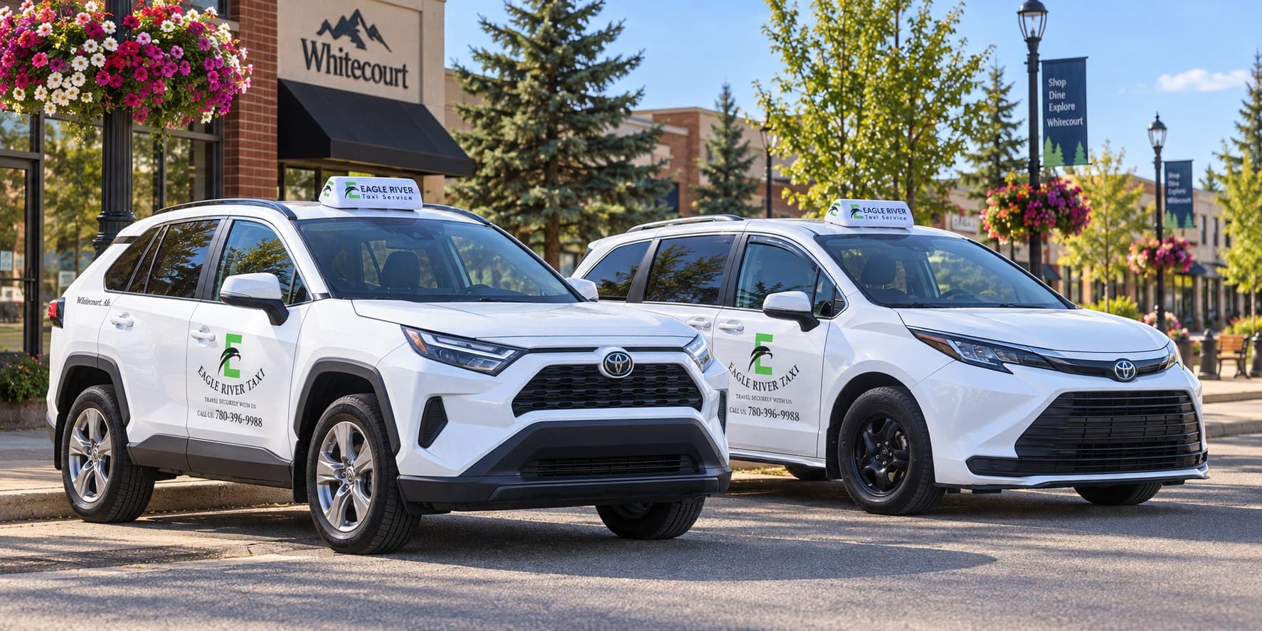 Branded Eagle River Taxi vehicles beside flowers in Whitecourt.
